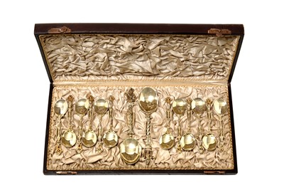 Lot 2375 - A Cased Set of Twelve German Silver-Gilts Teaspoons and a Pair of Serving Spoons