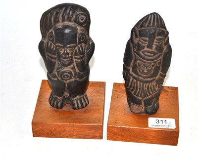 Lot 311 - Two Pre-Columbian style black earthenware figures, one standing with his hands raised to his...