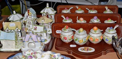 Lot 317 - Ten Coalport cottages and a set of twelve Franklin Mint preserve jars, covers and spoons on a...