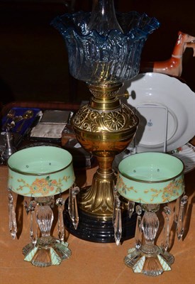 Lot 335 - Brass and blue glass oil lamp and a pair of table lustres