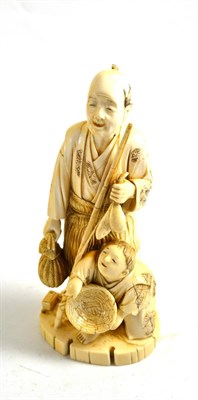 Lot 349 - A Japanese elephant ivory figure of a peasant and child, circa 1910