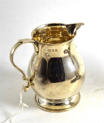 Lot 357 - A silver jug in Georgian style, London 1933