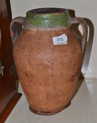 Lot 370 - A medieval pottery double handled jar