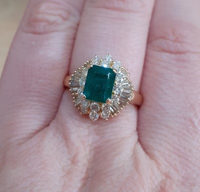 Lot 2100 - An 18 Carat Gold Emerald and Diamond Cluster...