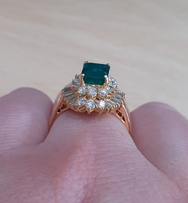 Lot 2100 - An 18 Carat Gold Emerald and Diamond Cluster...