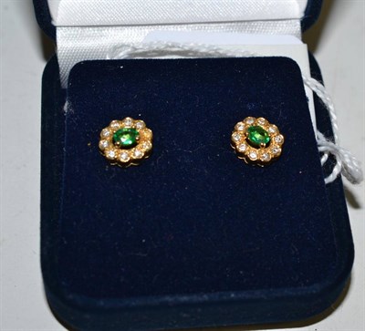 Lot 384 - A pair of 18ct gold emerald and diamond cluster earrings