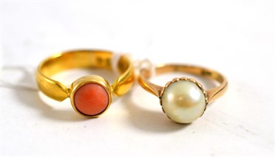 Lot 385 - A 22ct gold coral ring and a pearl type ring