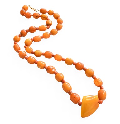 Lot 1048 - An Amber and Coral Bead Necklace, the...