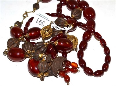 Lot 391 - An amber necklace and an amber and carved nut bead necklace