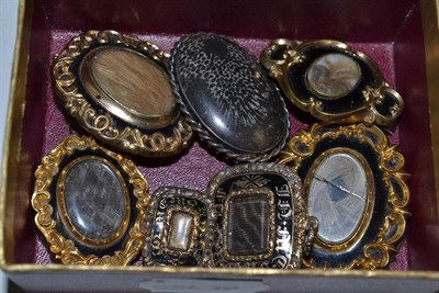 Lot 416 - Six various black enamelled mourning brooches and a hardstone brooch (7)