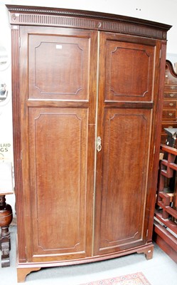 Lot 1146 - A Mahogany Bow Front Double Wardrobe, by...