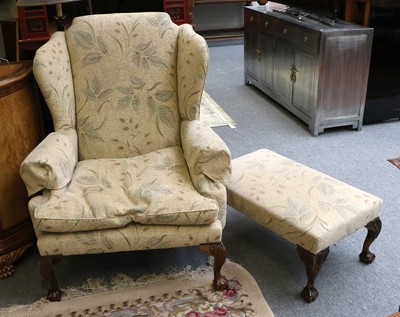 Lot 1300 - A Reproduction Wing-back Arm Chair, in the...