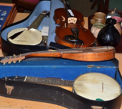 Lot 438 - Two cased banjo ukuleles, a mandolin and a violin