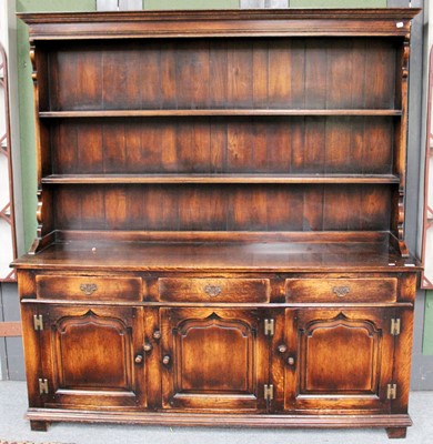 Lot 1129 - A Reproduction Oak Dresser and Rack in George...