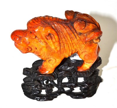 Lot 464 - An amber figure of a lion dog