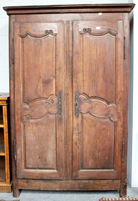 Lot 1131 - An 18th century French Oak Armoir, with carved...