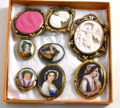 Lot 494 - Two Victorian shell cameo brooches, five various porcelain mounted brooches and a locket brooch