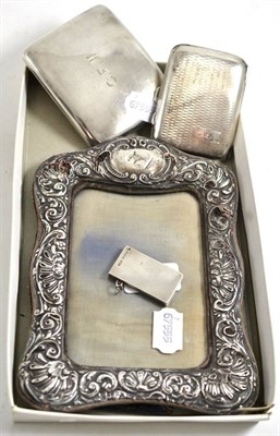 Lot 499 - A silver stamp holder, two cigarette cases and a silver framed mirror