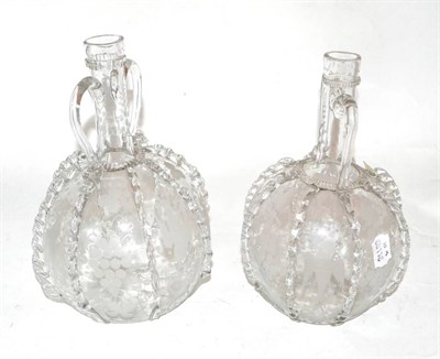 Lot 514 - A pair of 19th century Dutch two handled glass decanters with fruiting vine etched and prunted...