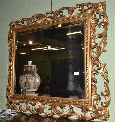 Lot 593 - A giltwood and composition framed wall mirror in the Florentine style