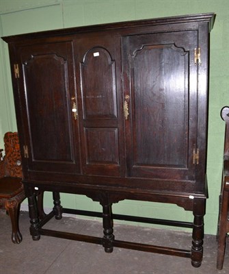 Lot 603 - An oak cupboard on stand