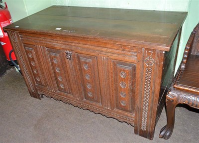 Lot 605 - A carved oak panelled coffer