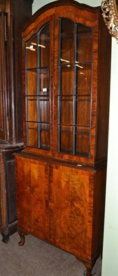 Lot 613 - A walnut display cabinet on a cupboard base