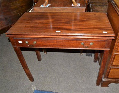 Lot 634 - A Georgian mahogany foldover tea table