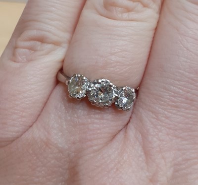 Lot 2008 - A Diamond Three Stone Ring the round brilliant...