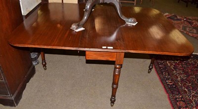 Lot 636 - A 19th century mahogany drop leaf dining table on fly leg supports