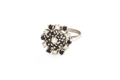 Lot 65 - A Sapphire and Diamond Cluster Ring, the...