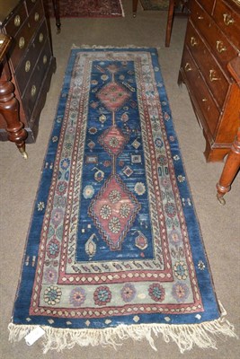 Lot 641 - A narrow Tefzet runner, East Europe, the indigo field with a column of stepped medallions...