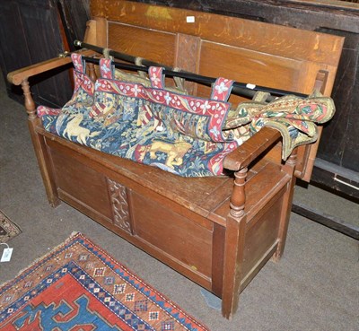 Lot 650 - An oak monks bench and two machine woven tapestry wall hangings