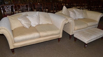 Lot 670 - A pair of cream upholstered hump back settees and a footstool