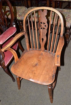 Lot 676 - A 19th century ash and elm wheel back Windsor chair with arms