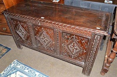 Lot 698 - An 18th century oak linen chest with triple lozenge carved facia