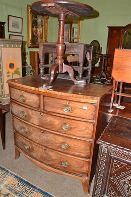 Lot 699 - A late Georgian mahogany bowfront four height chest and a mahogany tripod table (a.f.)