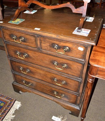 Lot 705 - A reproduction oak small four height chest