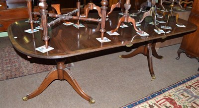 Lot 714 - A mahogany twin pillar dining table with additional leaf