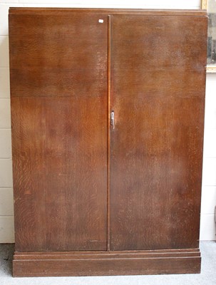 Lot 1182 - A 1940s Oak Gentlemans Compactom Wardrobe,...