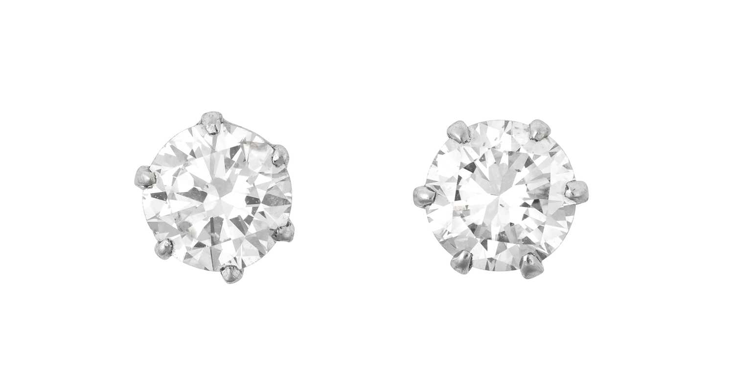 Lot 2035 - A Pair of Diamond Solitaire Earrings the round...
