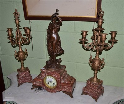 Lot 725 - A marble and figural clock garniture