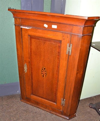 Lot 731 - A Georgian oak and mahogany corner cupboard