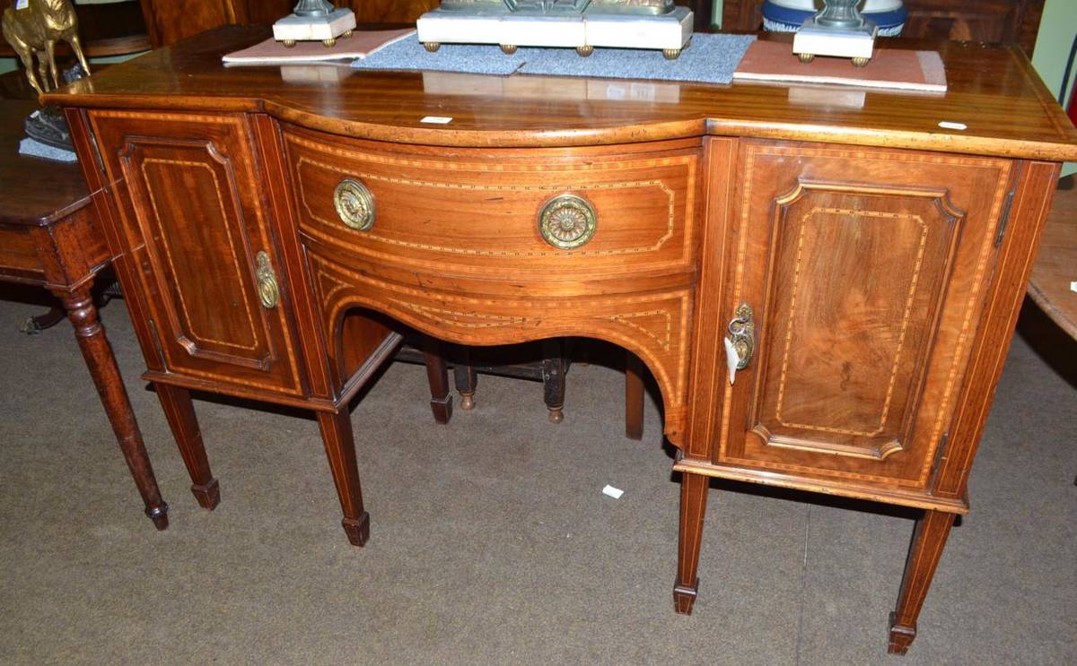 Lot 734 - An Edwardian Neo-classic revival inlaid mahogany break bow front sideboard