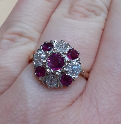 Lot 2087 - An 18 Carat Gold Ruby and Diamond Cluster Ring...