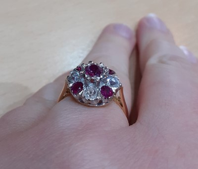 Lot 2087 - An 18 Carat Gold Ruby and Diamond Cluster Ring...