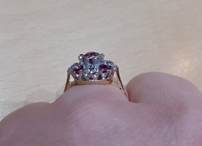 Lot 2087 - An 18 Carat Gold Ruby and Diamond Cluster Ring...