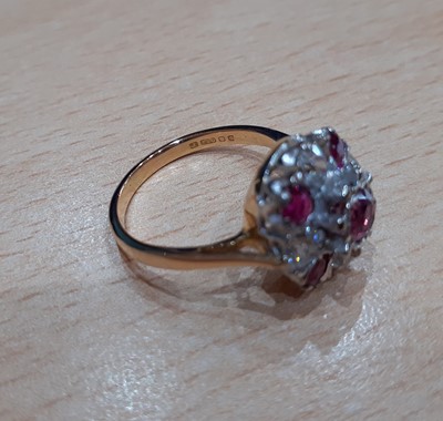 Lot 2087 - An 18 Carat Gold Ruby and Diamond Cluster Ring...