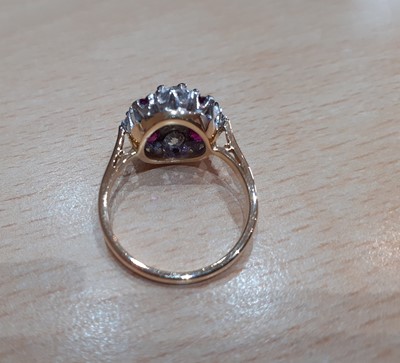 Lot 2087 - An 18 Carat Gold Ruby and Diamond Cluster Ring...