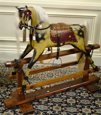 Lot 763 - Early 20th century Norton & Barker dapple grey rocking horse on treadle base, with original paint